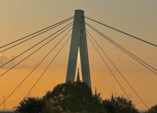 Sunset photograph of a modern bridge structure on Cologne by Bojan Stojanović.